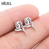 Intriguing rose-shaped silver stud earrings, unique floral jewelry on fingertips, delicate style