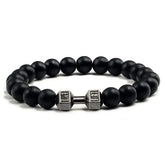 Matte black beaded bracelet with a unique silver dumbbell charm, perfect for bold style