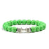 Vivid green beaded bracelet with unique silver dumbbell charm, a striking jewelry accent