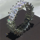 Dazzling silver eternity ring with radiant baguette-cut stones, perfect for unique style seekers.