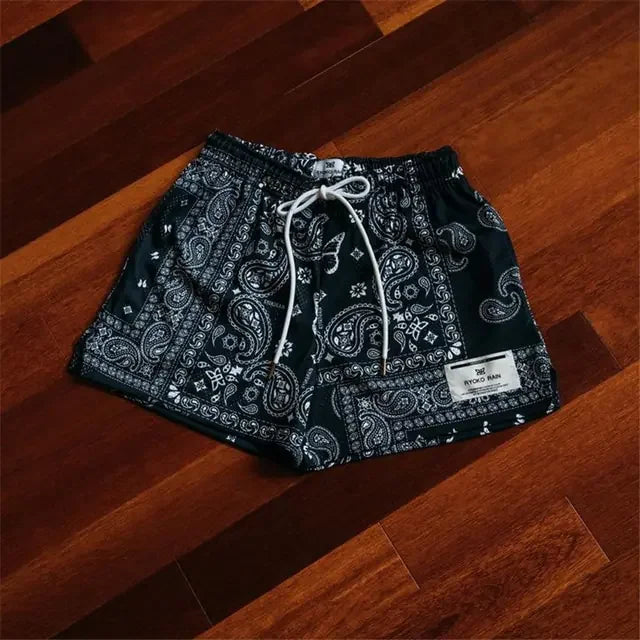 Trendy black paisley shorts with drawstring waist, perfect for a unique casual look