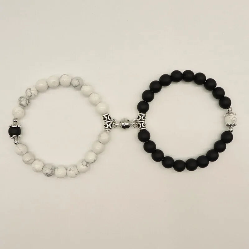 Set of unique black and white beaded bracelets with ornate silver accents, sparking curiosity.