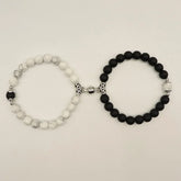 Set of unique black and white beaded bracelets with ornate silver accents, sparking curiosity.