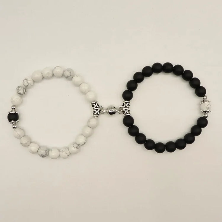 Set of unique black and white beaded bracelets with ornate silver accents, sparking curiosity.