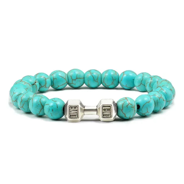 Striking turquoise bead bracelet with unique silver dumbbell charm, perfect for bold style.