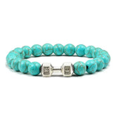 Striking turquoise bead bracelet with unique silver dumbbell charm, perfect for bold style.