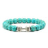 Striking turquoise bead bracelet with unique silver dumbbell charm, perfect for bold style.