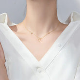 Elegant gold cross necklace with sparkling stones, perfect for a unique, stylish look.