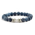 Blue stone beaded bracelet with unique silver dumbbell charm, perfect for stylish individuality.