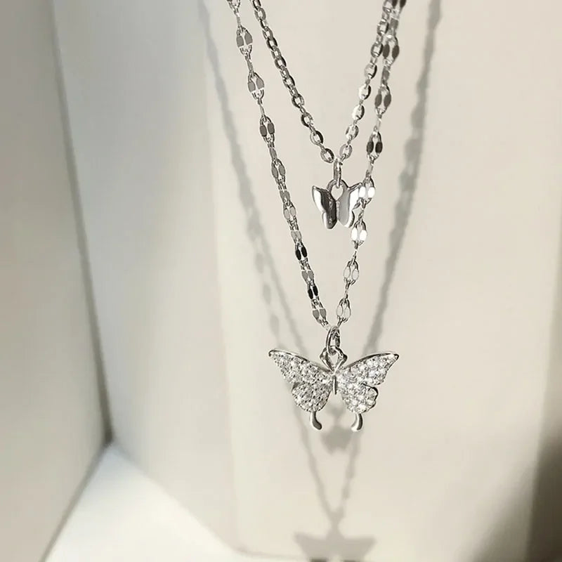 Sparkling silver butterfly layered necklace catches the light, inviting curiosity and elegance.
