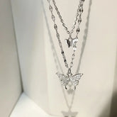 Sparkling silver butterfly layered necklace catches the light, inviting curiosity and elegance.