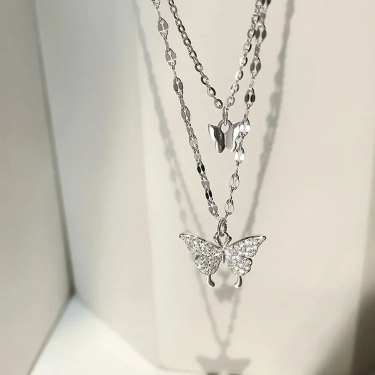 Sparkling silver butterfly layered necklace catches the light, inviting curiosity and elegance.