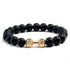 Matte black beaded bracelet with unique gold dumbbell accent, bold and stylish look
