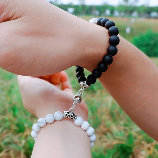Curiously unique black and white beaded couple bracelets linked outdoors, stylish and meaningful