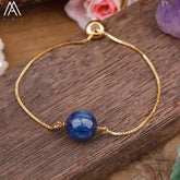 Elegant gold bracelet with striking blue gemstone, a unique jewelry piece for standout style