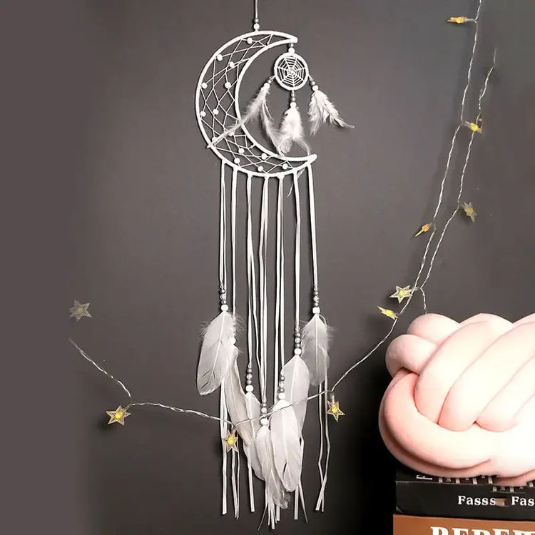 Unique crescent moon dreamcatcher with white feathers and beads, perfect for stylish wall decor.