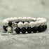 Elegant black and white stone bead bracelets with intricate silver accents, unique jewelry style