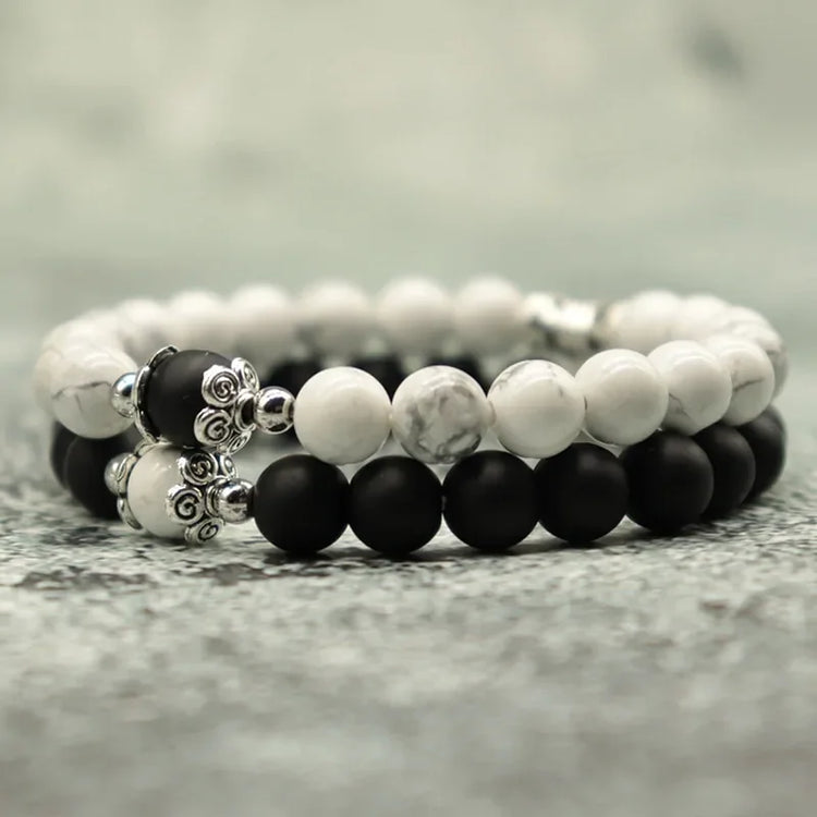 Elegant black and white stone bead bracelets with intricate silver accents, unique jewelry style