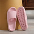 Soft pink slide slippers with textured sole and open toe, perfect for unique, stylish comfort.