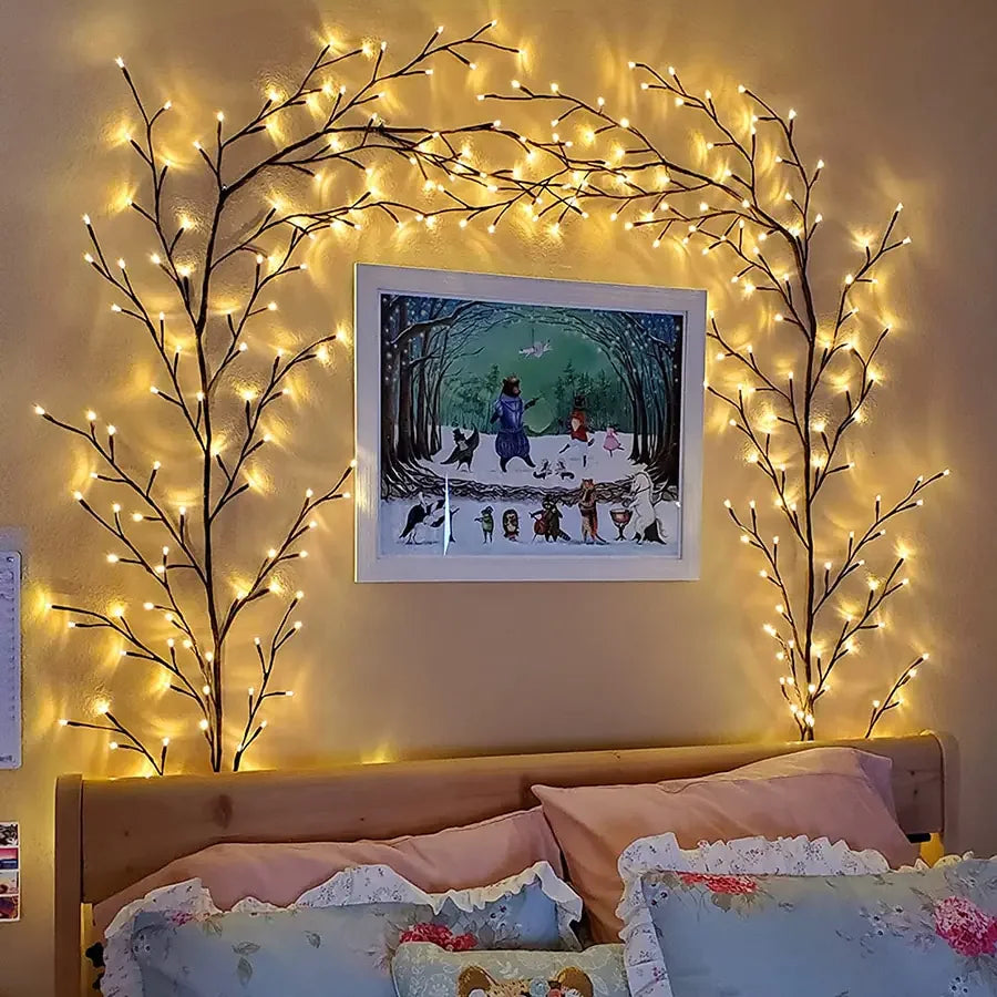 Unique branch string lights frame whimsical wall art above cozy bed, enchanting home décor