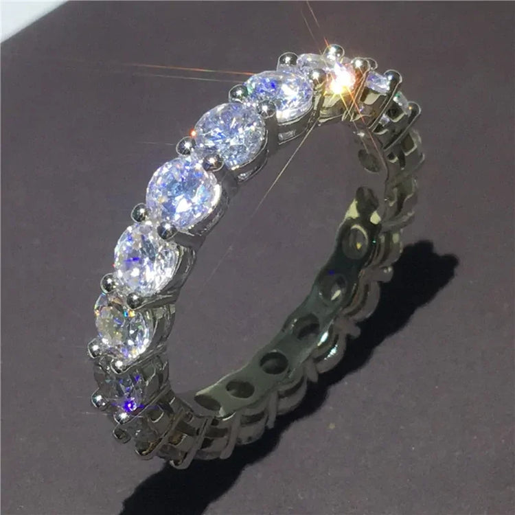 Dazzling eternity ring with oval-cut stones sparkling on sleek, modern silver band