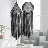 Unique black lace dreamcatchers with geometric patterns add intrigue to a modern living room.