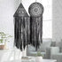 Unique black lace dreamcatchers with geometric patterns add intrigue to a modern living room.