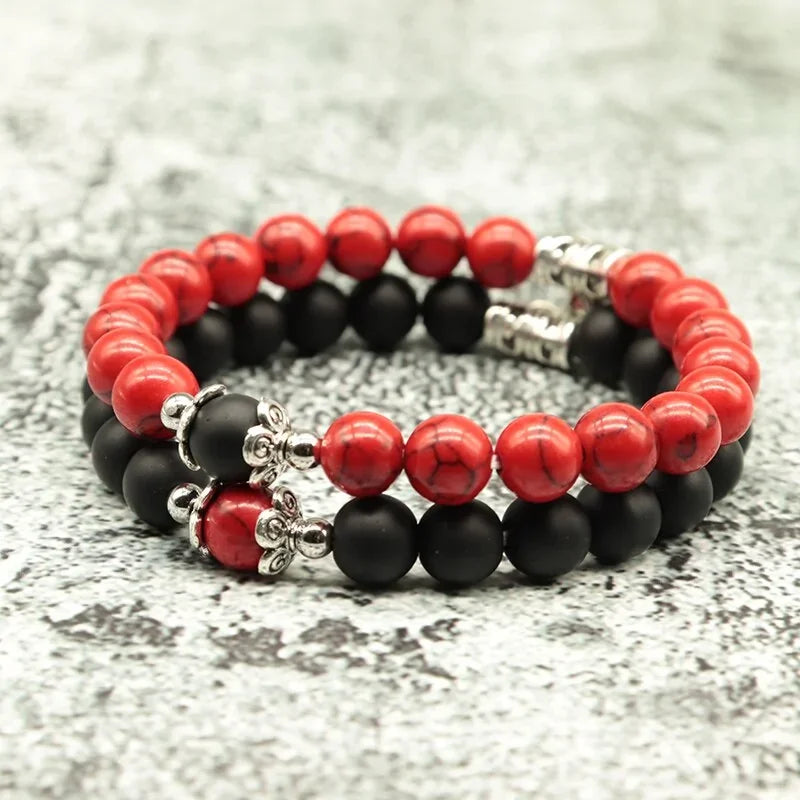 Intriguing red and black stone bead bracelet with silver accents on textured surface