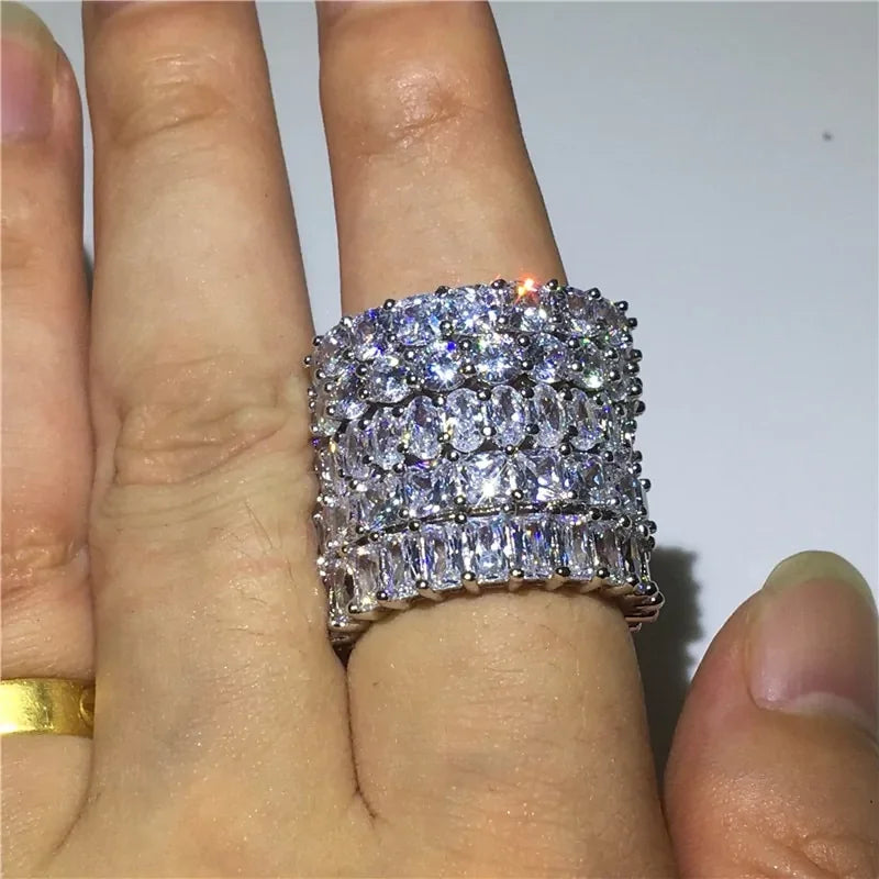 Dazzling wide silver ring with multiple rows of sparkling clear gemstones, uniquely eye-catching