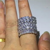 Dazzling wide silver ring with multiple rows of sparkling clear gemstones, uniquely eye-catching