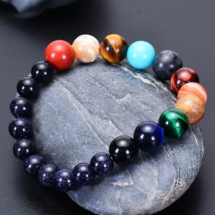 Vibrant gemstone bead bracelet on stone, showcases unique, colorful jewelry style