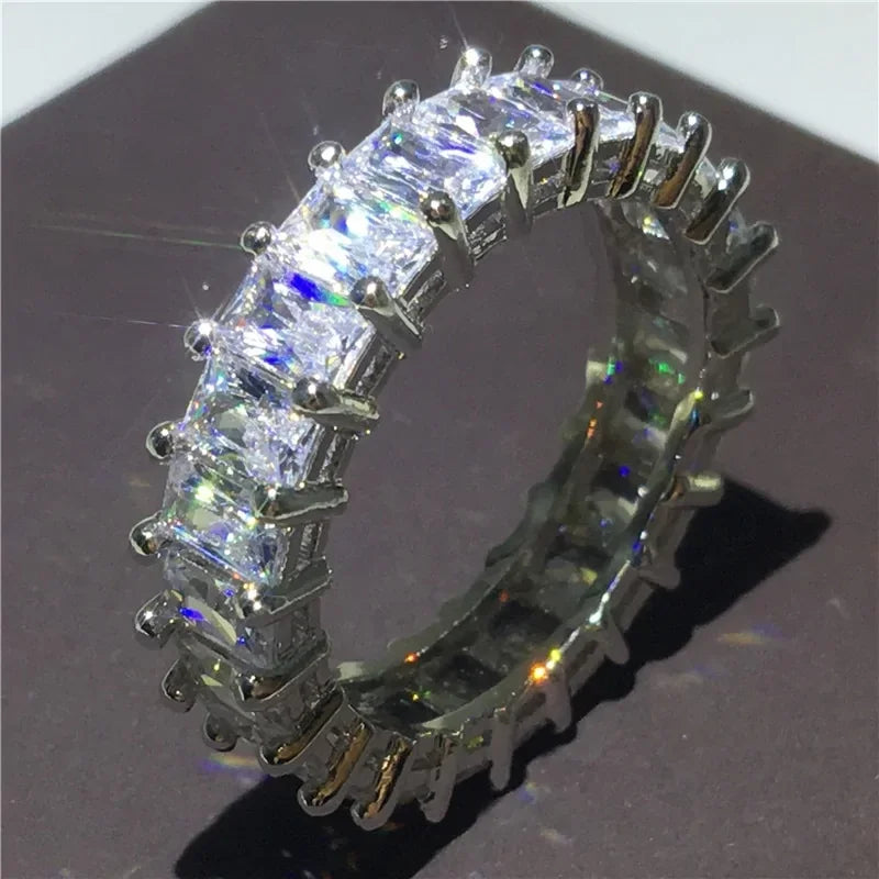 Sparkling eternity ring with radiant square-cut stones in a unique silver setting, eye-catching shine