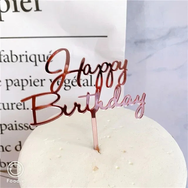 Elegant rose gold Happy Birthday cake topper adds unique charm to a minimalist white cake.