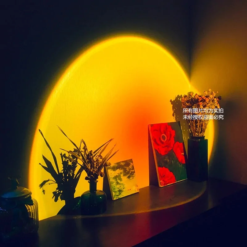 Warm yellow sunset projection lamp casting unique light on dried flowers and art, creating a stylish, inviting décor accent.