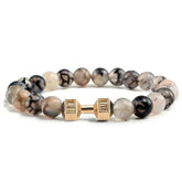 Eye-catching gemstone beaded bracelet with a unique gold-tone dumbbell charm, stylish and bold
