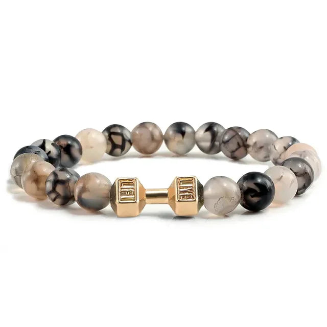 Eye-catching gemstone beaded bracelet with a unique gold-tone dumbbell charm, stylish and bold