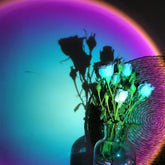 Elegant white roses in glass vase with vivid rainbow lighting, creating stylish home décor intrigue.