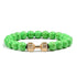 Vivid green beaded bracelet with unique gold dumbbell charm, perfect for standout personal style