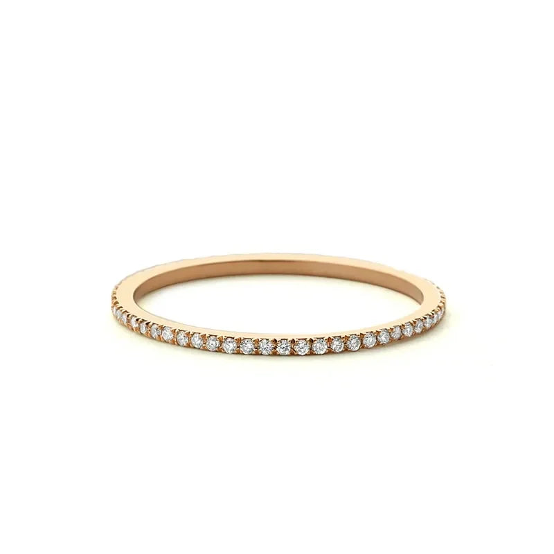 Dazzling rose gold eternity band adorned with sparkling stones, perfect for unique style seekers.