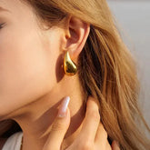 Captivating gold teardrop earring, bold modern jewelry that sparks curiosity and style.