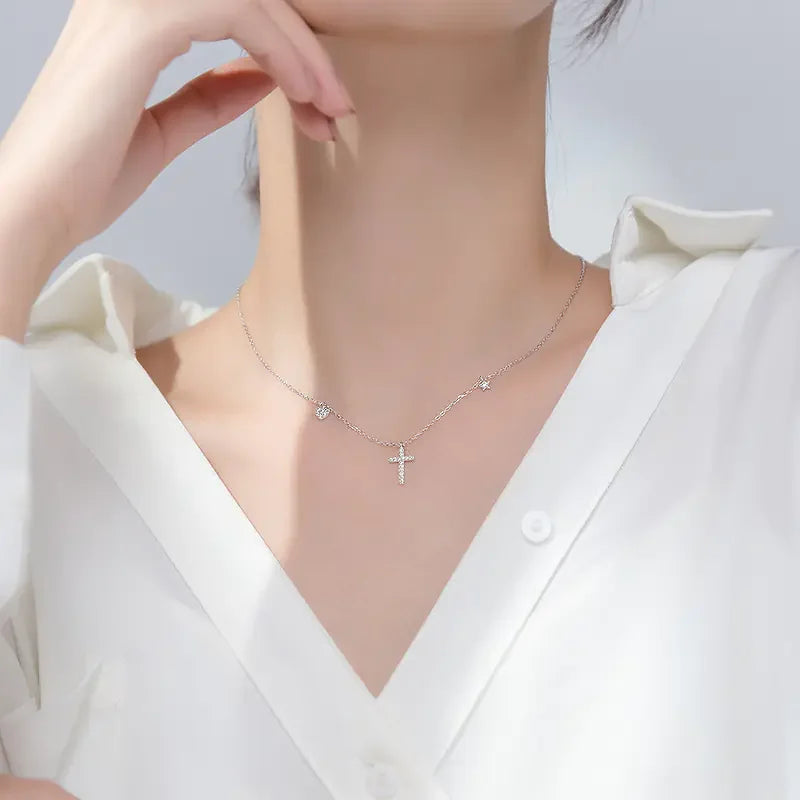 Elegant silver cross necklace with sparkling accents, perfect for a uniquely stylish look.
