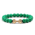 Striking green beaded bracelet with unique gold dumbbell charm, perfect for bold style seekers