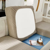 Modern beige sofa with unique geometric-patterned cushion, cozy home décor accent