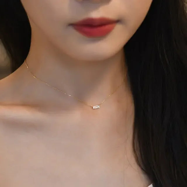 Delicate gold necklace with sparkling bar pendant, perfect for adding unique elegance