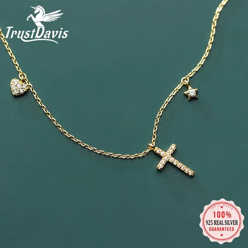 Sparkling gold chain necklace with crystal cross, heart, and star charms for a unique look