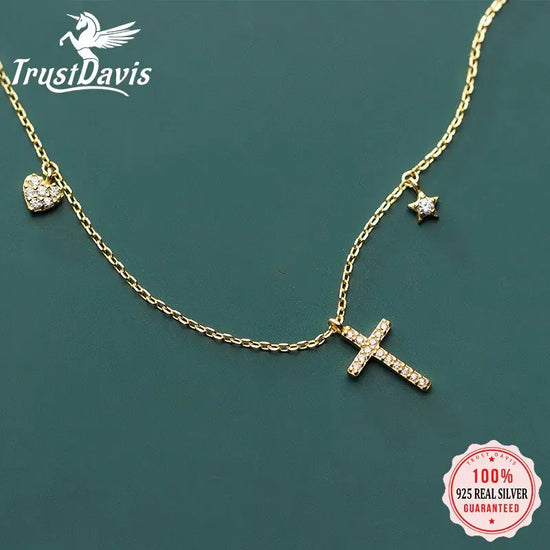 Sparkling gold chain necklace with crystal cross, heart, and star charms for a unique look
