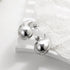 Shiny silver abstract stud earrings on elegant white lace, modern and unique jewelry design