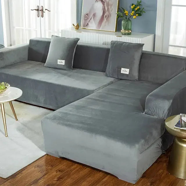 Chic gray velvet sectional sofa in modern living room with unique gold accent décor, inviting curiosity.