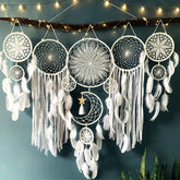 Intricate white dreamcatchers with feathers and moon charm, glowing fairy lights, unique wall décor