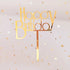 Chic gold Happy Birthday cake topper with shimmering star confetti, creating a magical vibe.